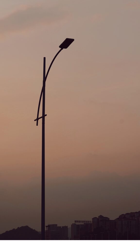 Street light pole against an evening sky
