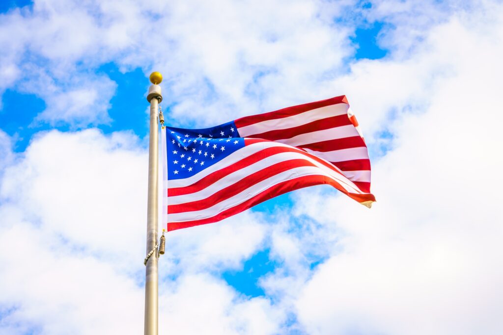 American flag on a flagpole against a blue sky