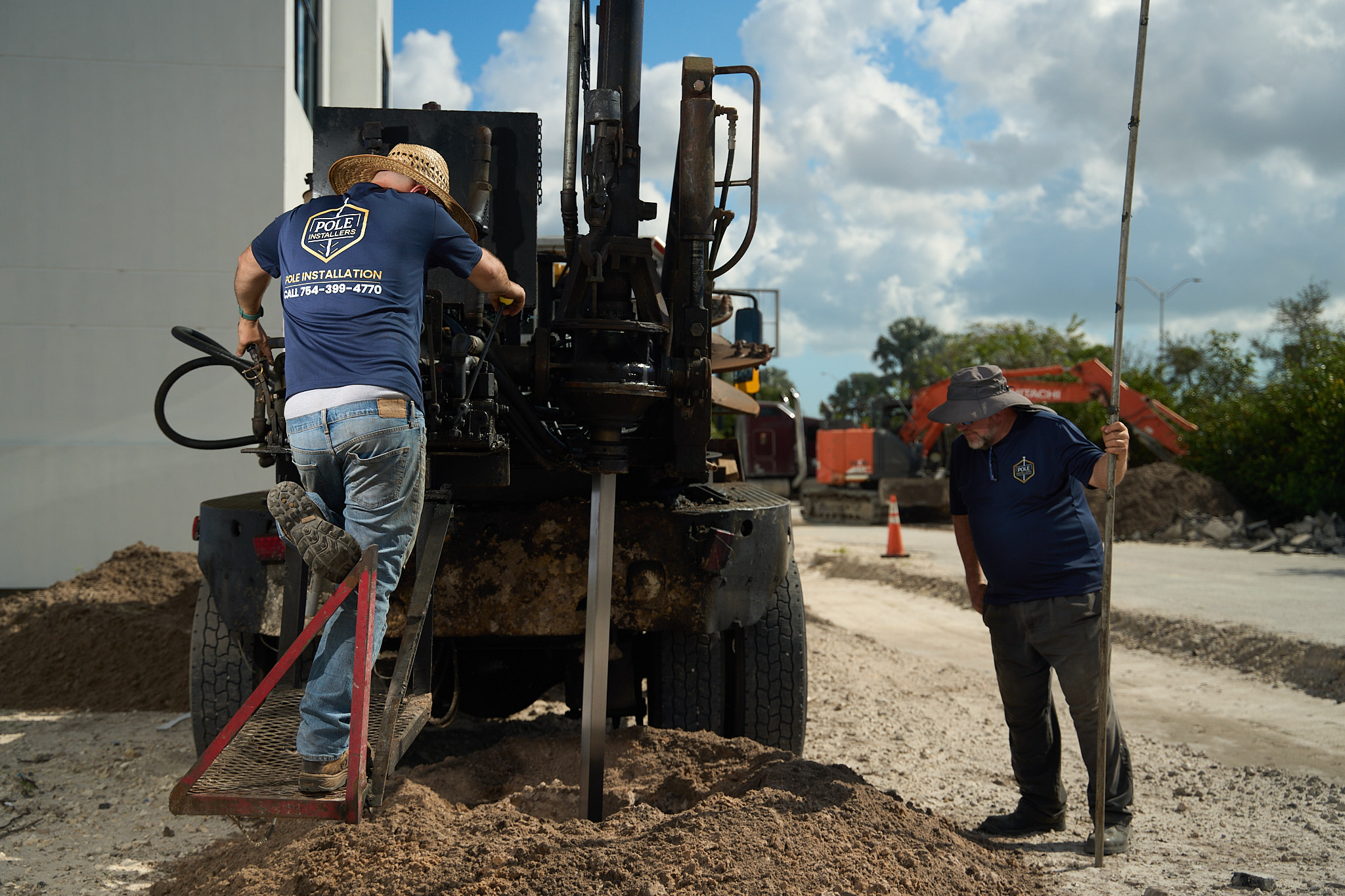 Pole Installers crew drilling a sign pole foundation