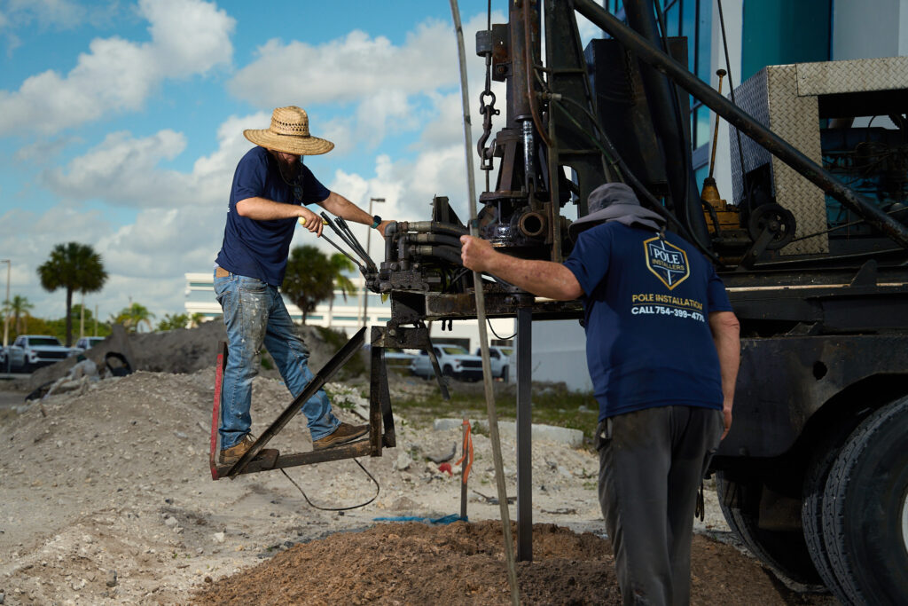 Pole Installers crew operating a pressure drilling rig