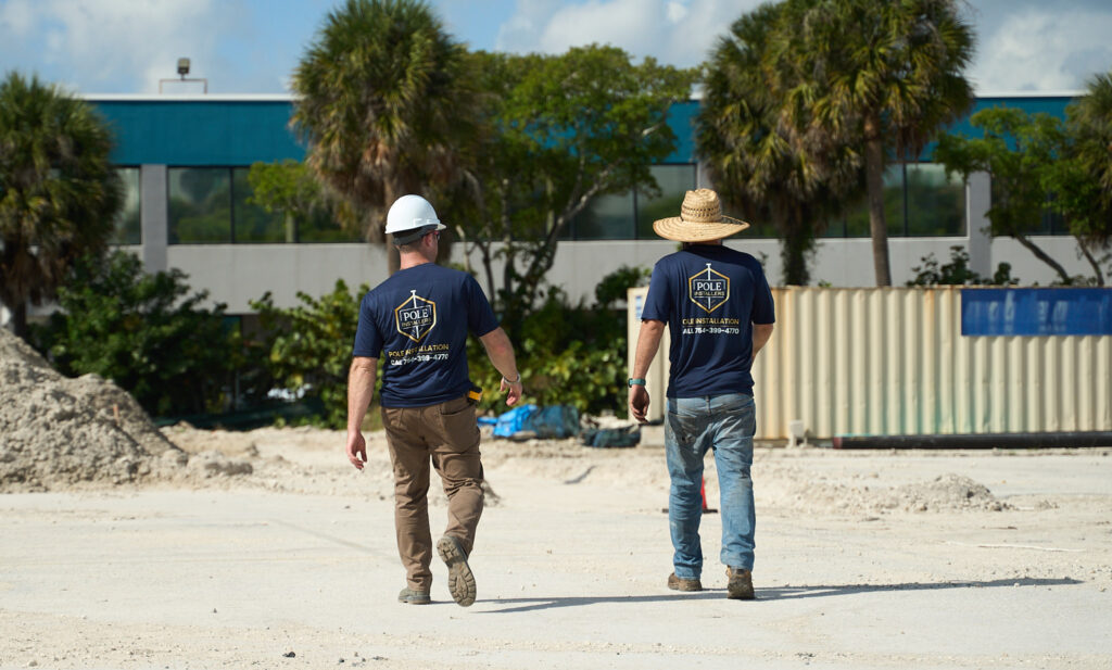 Pole Installers crew walking a commercial job site